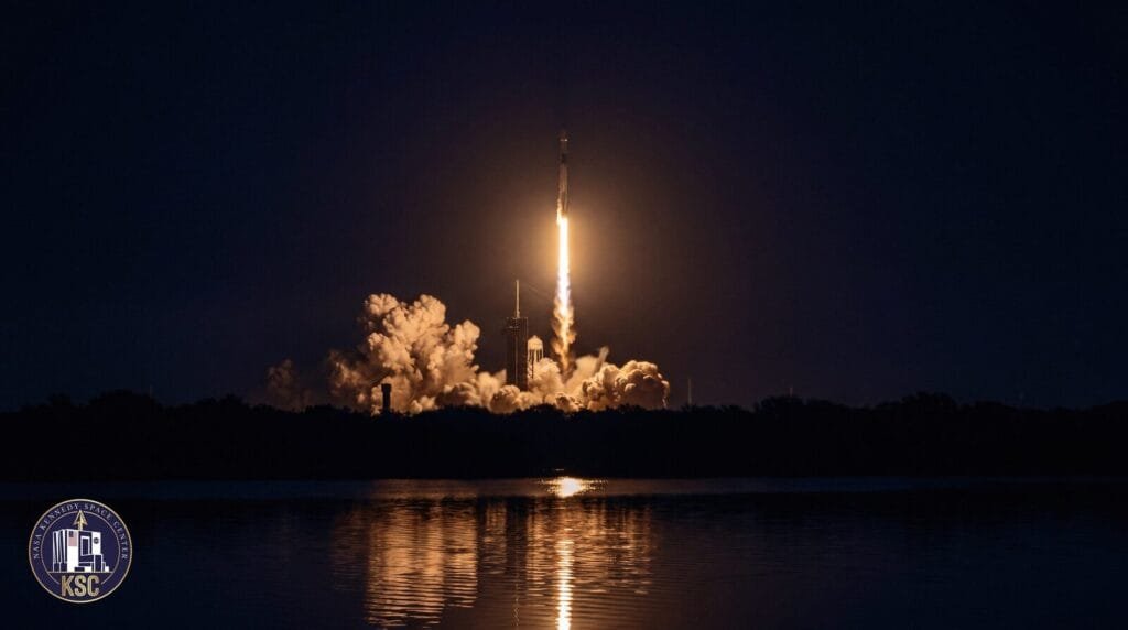 A night rocket launch on the Space Coast, reflected in the water